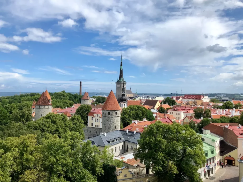 Old town rooftops and church spire under a blue sky